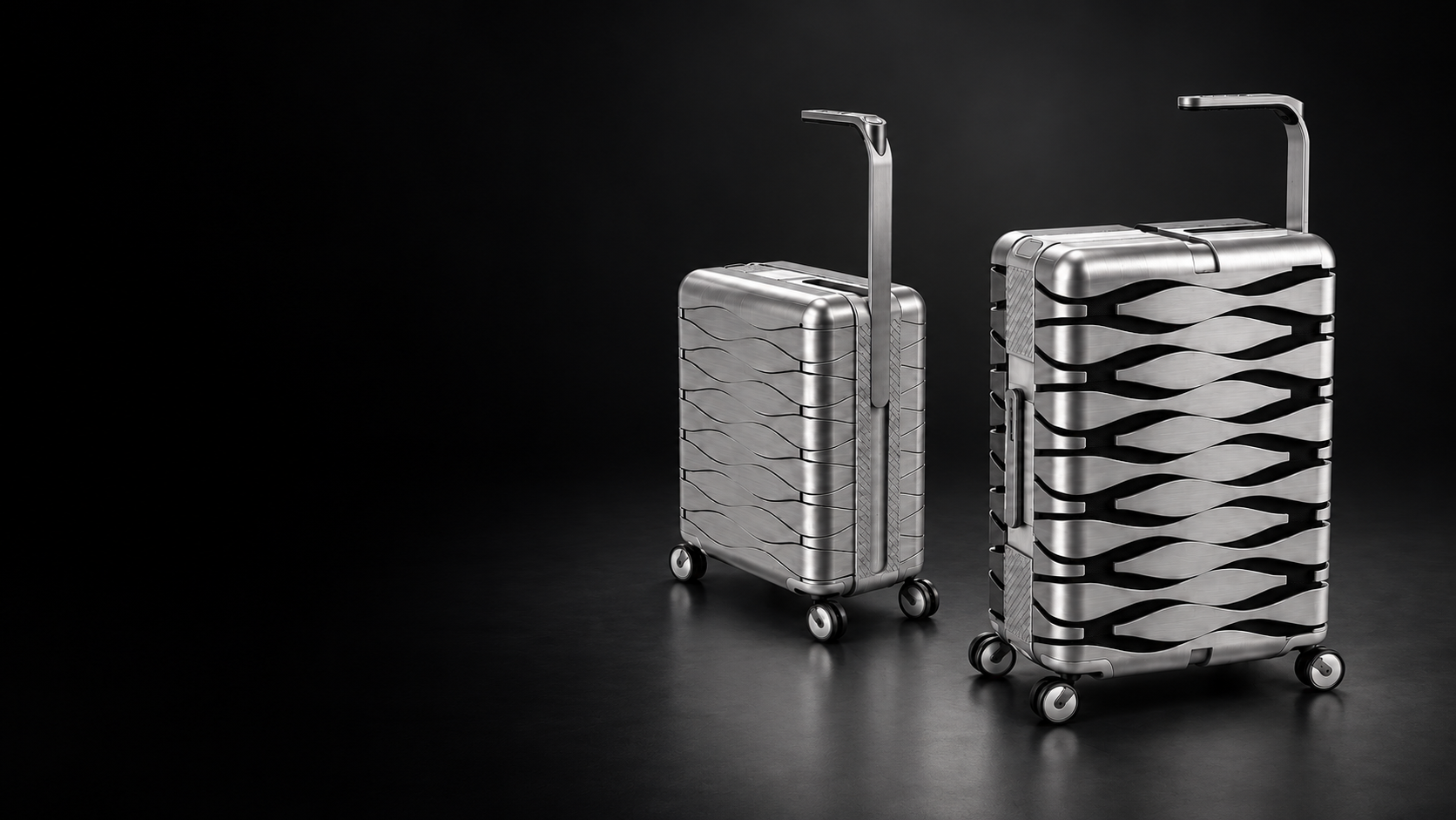 Two silver expandable wave-shell suitcases in a dark studio